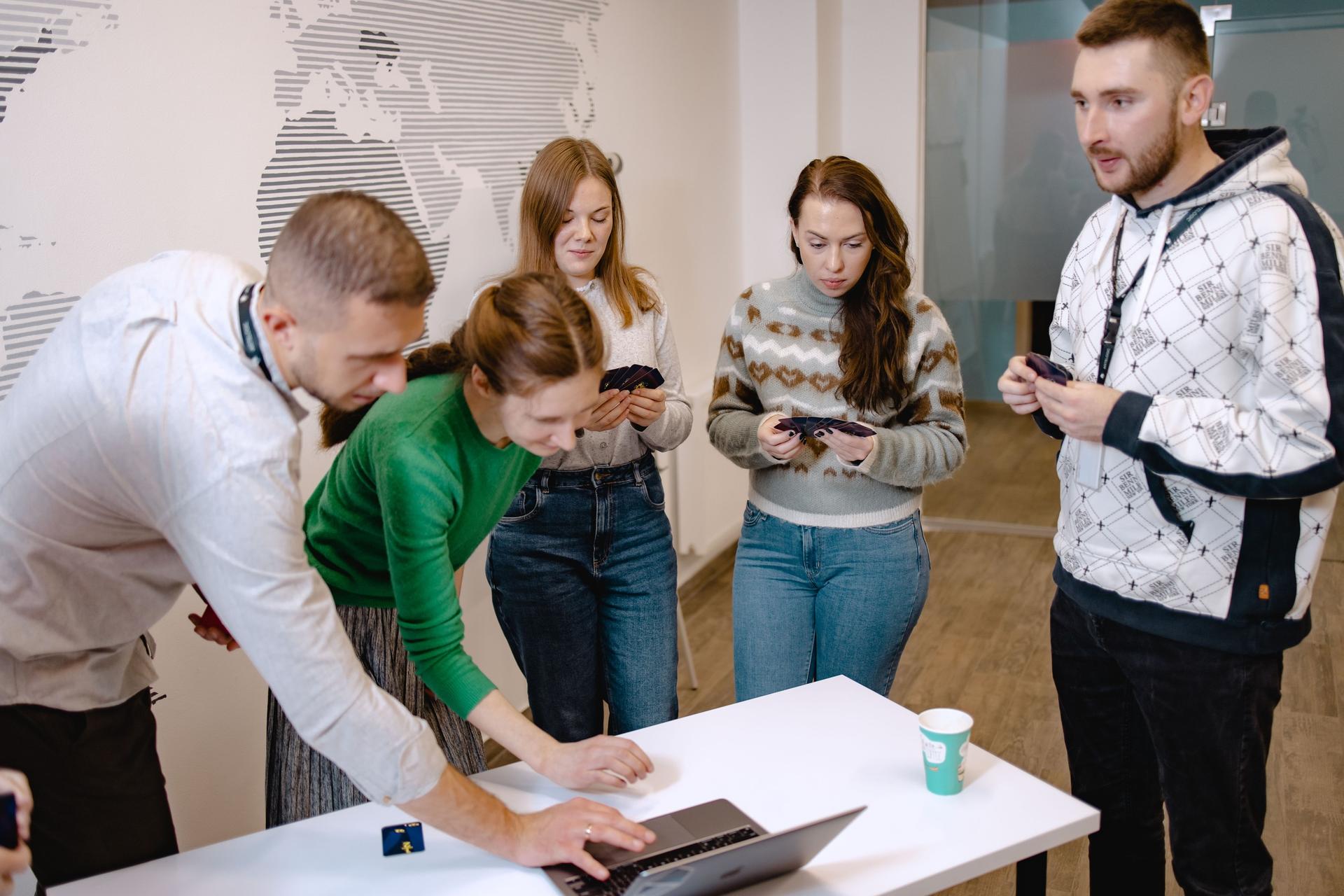 bloomio team collaborating around a laptop
